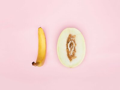 a banana and a half of a melon on a pink background